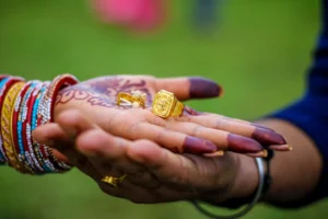 Close-up of hands adorned with mehndi and jewelry, demonstrating cultural richness and tradition.