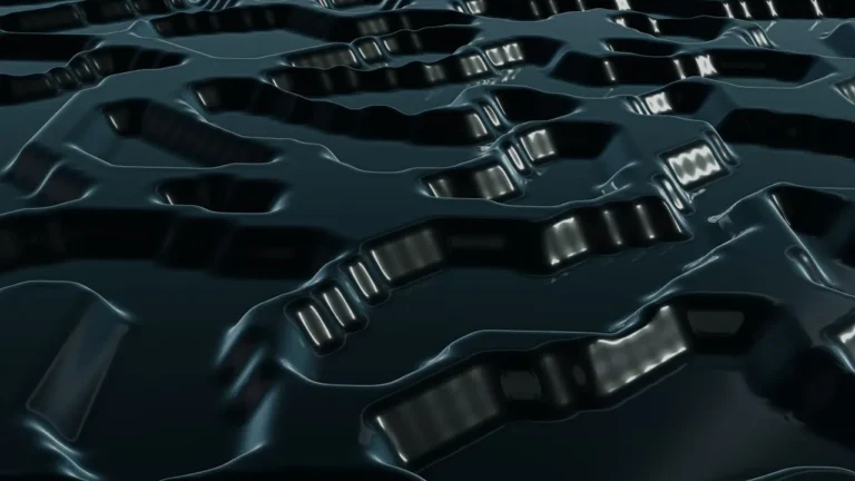 Abstract black metallic surface featuring intricate patterns and textures for creative backgrounds.