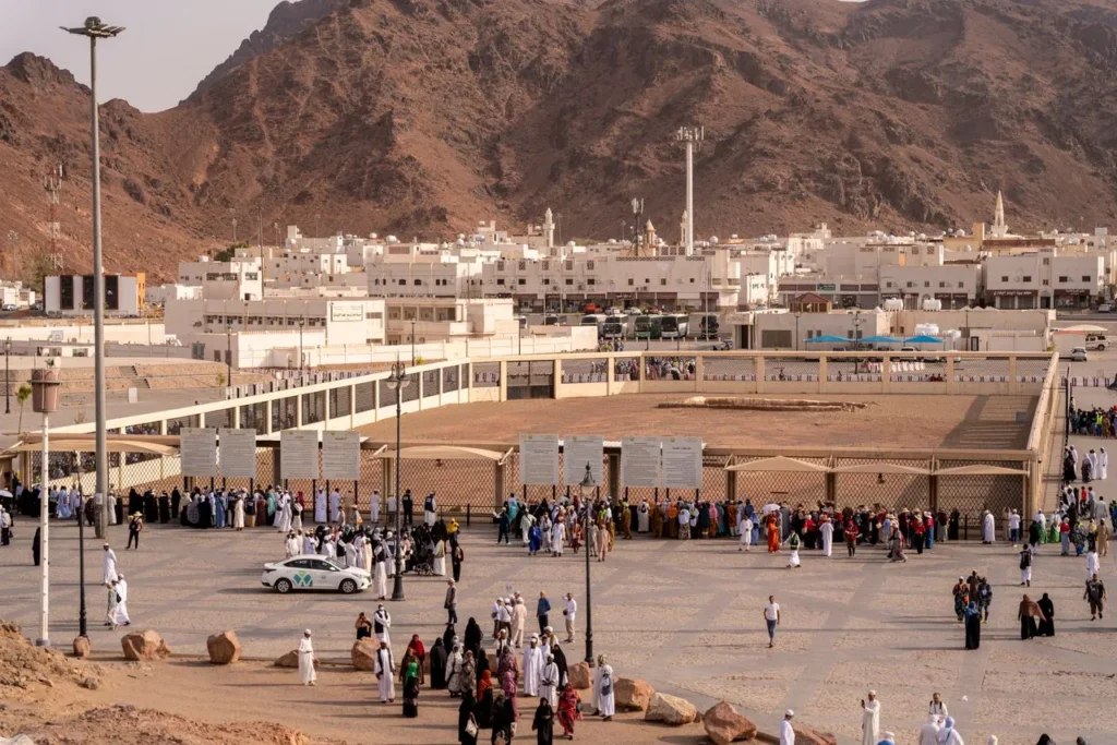 A bird’s-eye view of a historic location in Medina, Saudi Arabia, with people gathering.